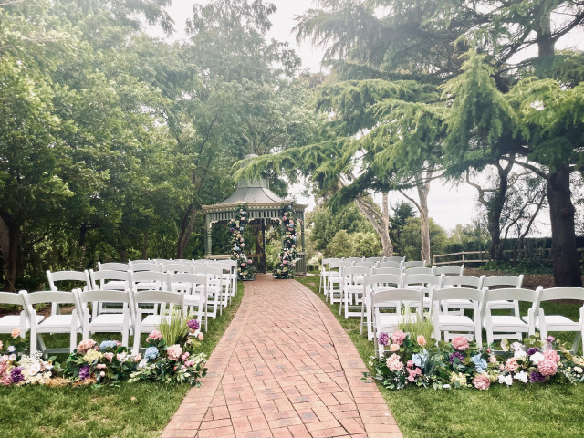 Arch florals and matching aisle arrangements